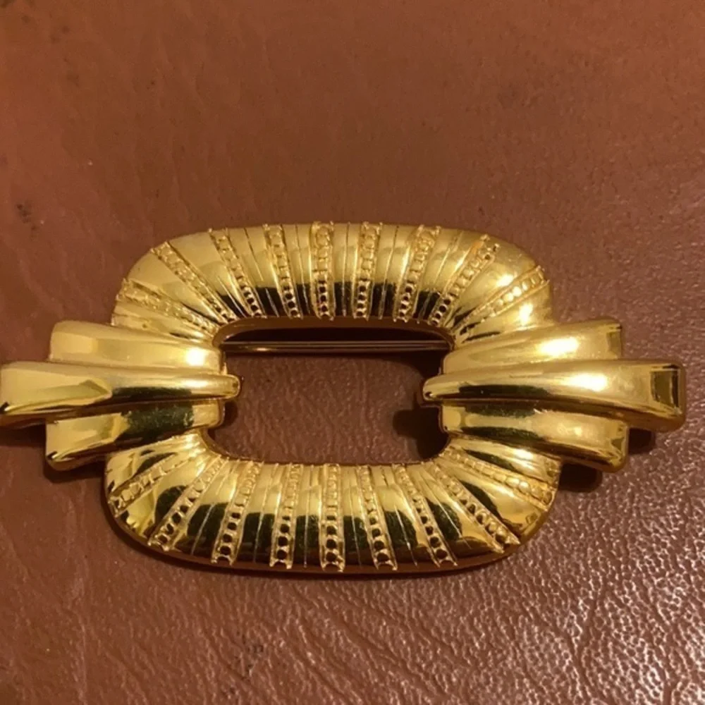 TAT signed gold tone Art Deco style pin